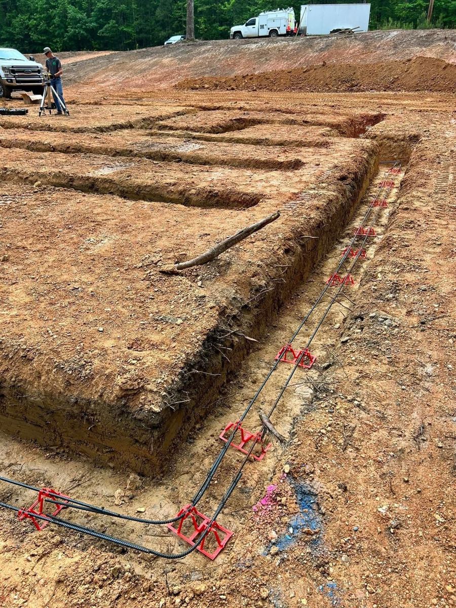 Footings dug into red clay with rebar chairs set