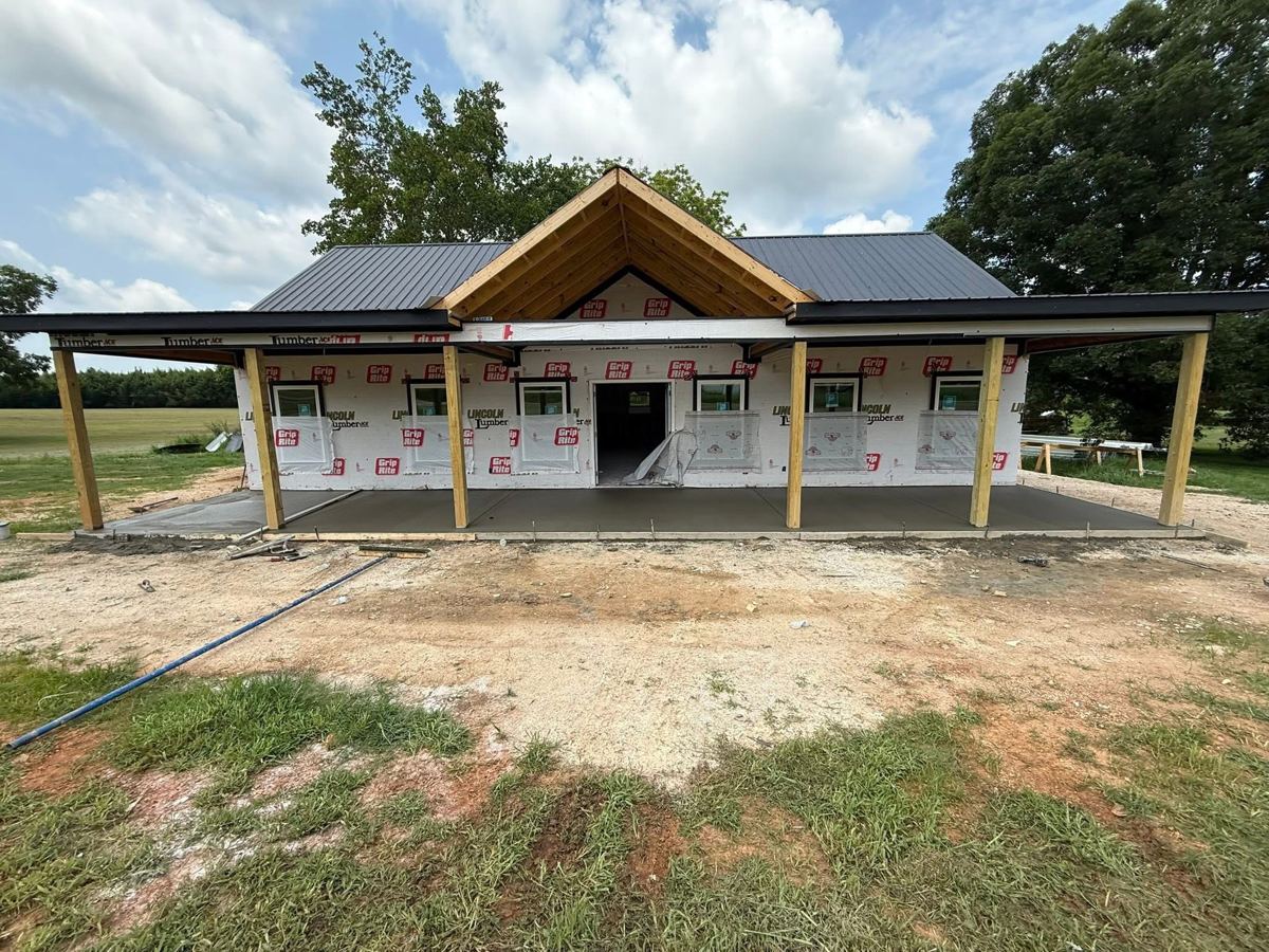 A new house under construction with a wide front porch